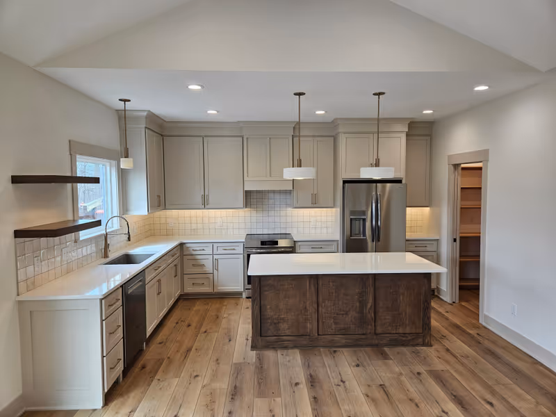 Custom kitchen with reclaimed-wood plank ceiling, two-tone shaker cabinetry, and tile backsplash